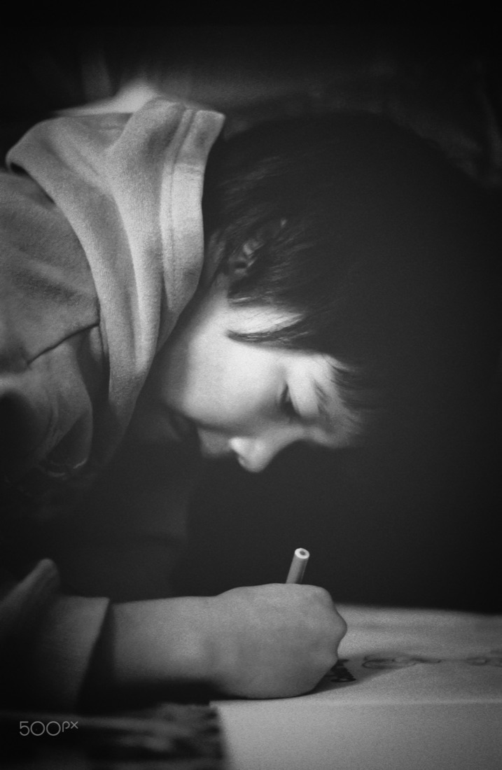 Black and white photo of a child drawing