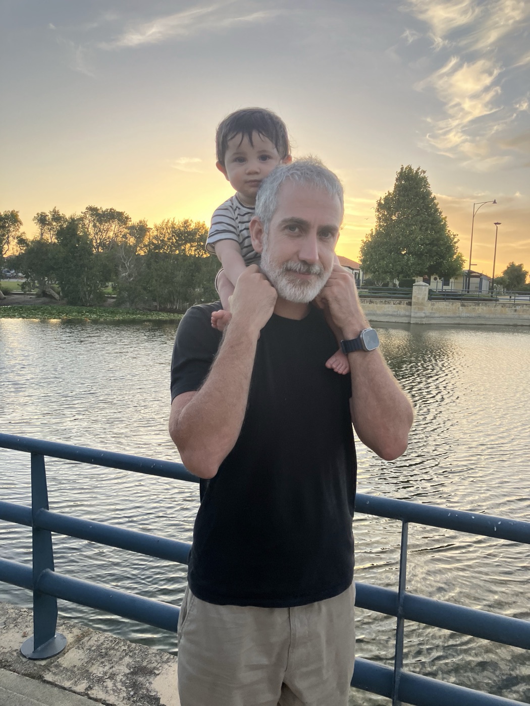Pierre at sunset by a lake in Perth, his youngest son riding on his shoulders