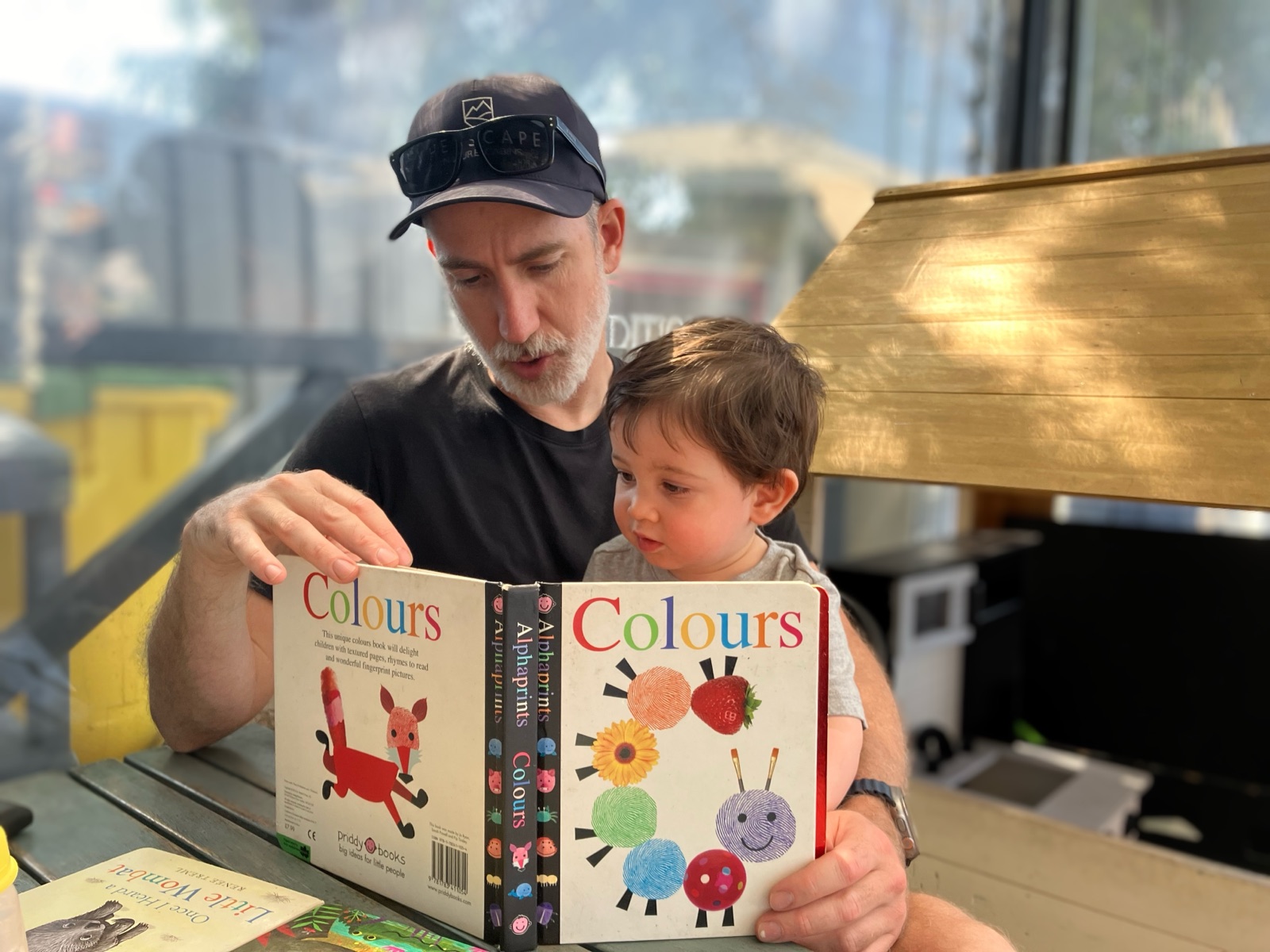Pierre reading a picture book about colours with his son